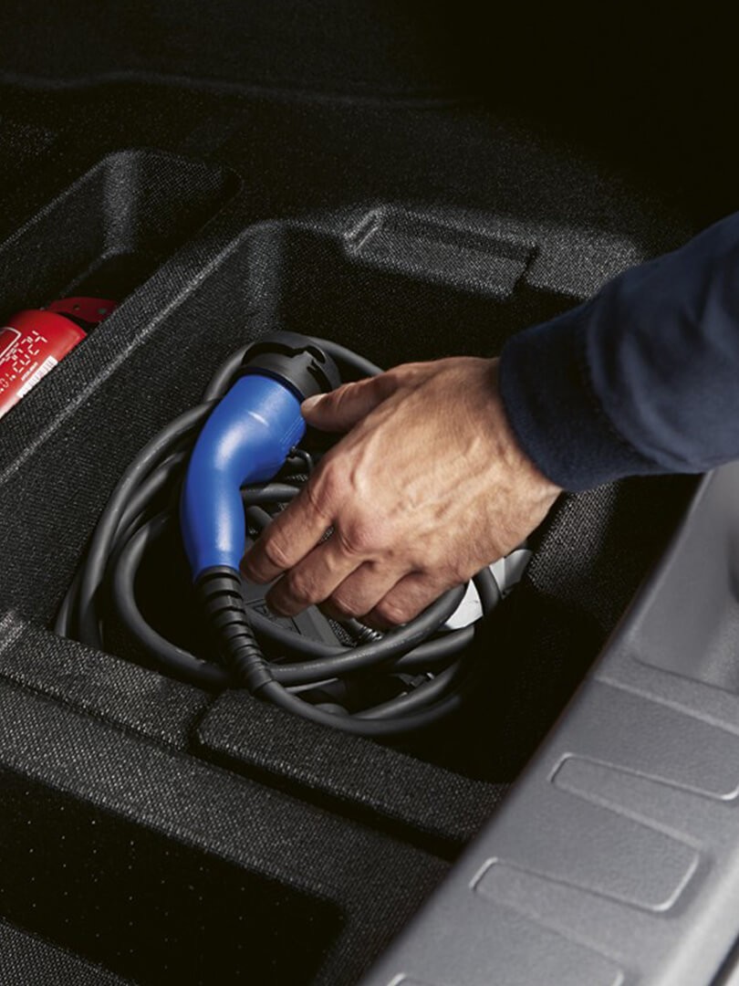 hand grasping a charging cable for Lexus car