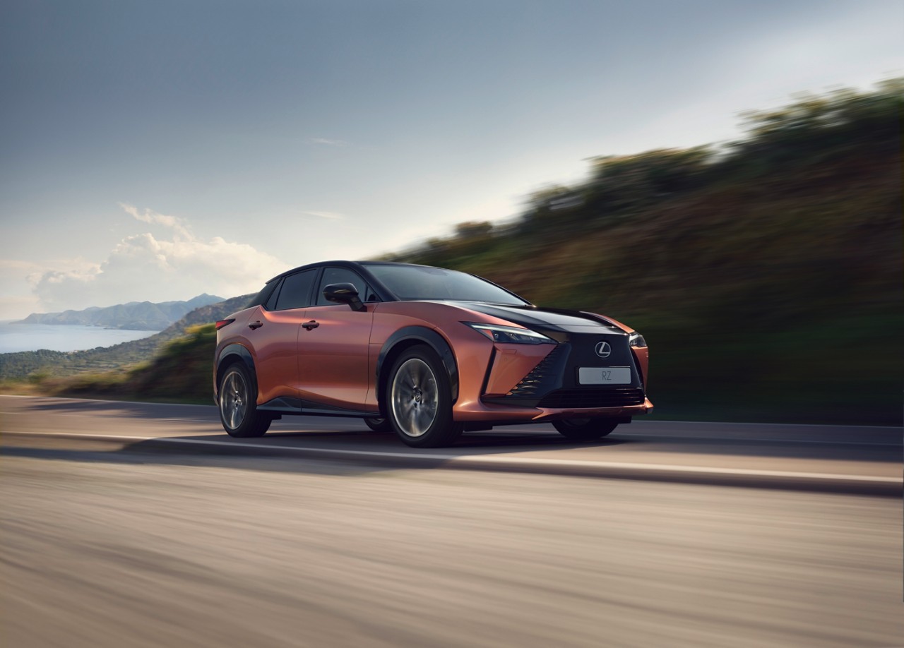 Lexus RZ driving down a road
