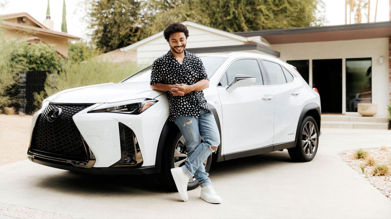 man leaning on a car