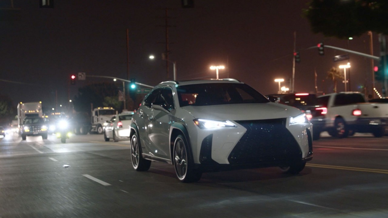 Lexus car surrounded by other cars on a road