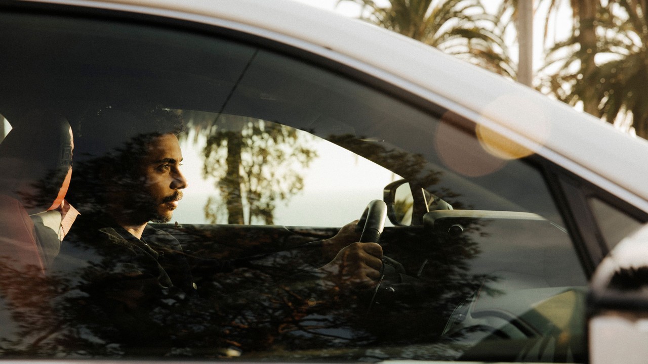 close up of Miles Thompson driving a Lexus UX