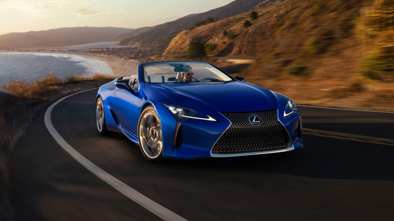 front shot of a Lexus LC Convertible driving along a road
