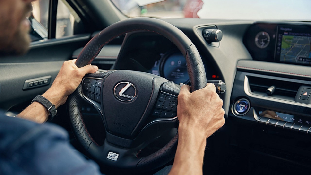 hands on a Lexus steering wheel