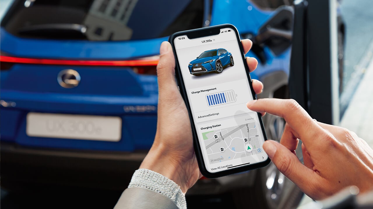 person using a phone with a Lexus UX300e on screen