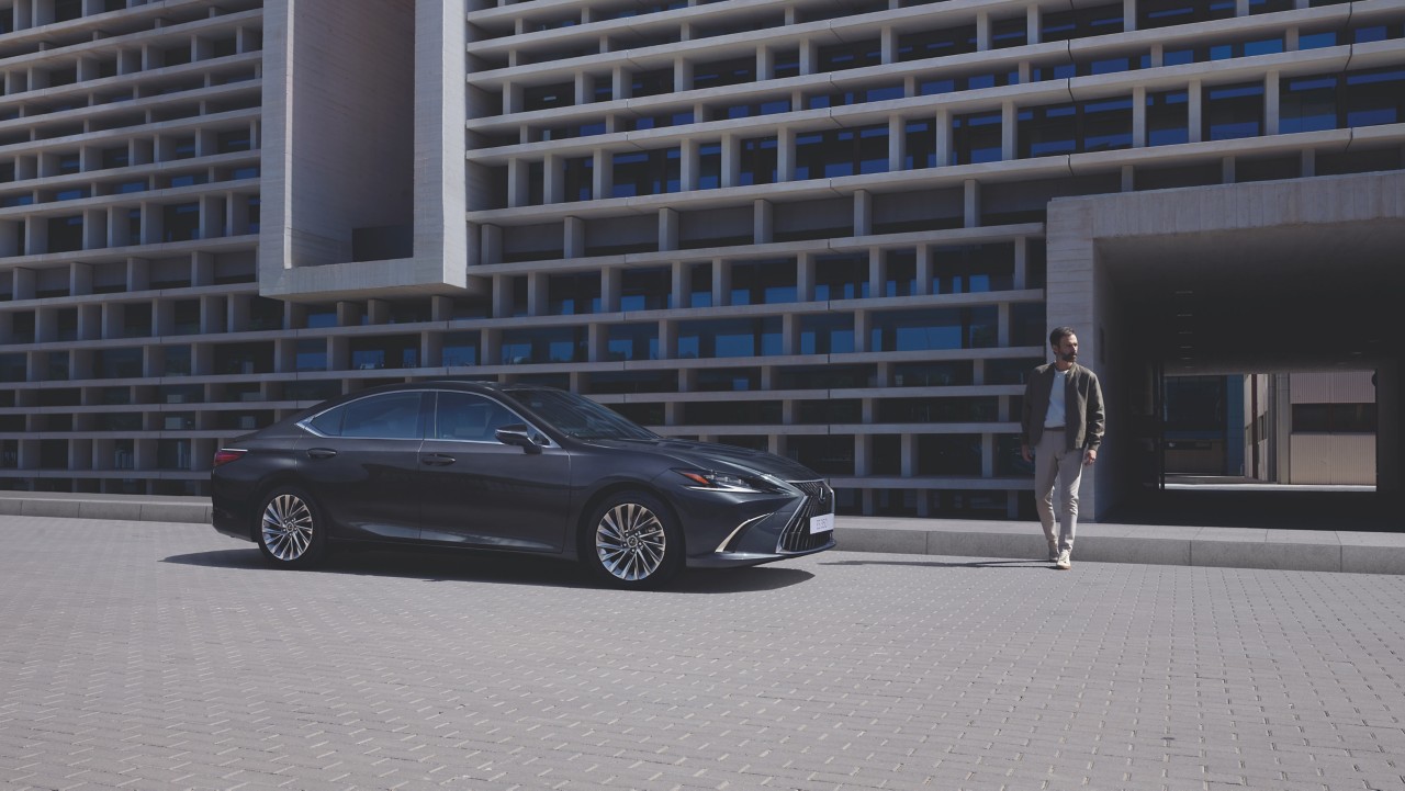 man walking towards a Lexus ES