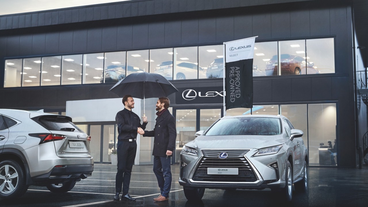 two people shaking hands at a Lexus centre