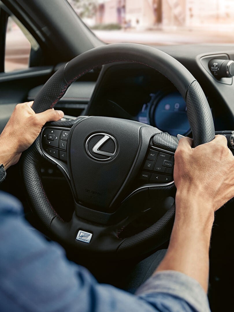 two hands on a Lexus steering wheel