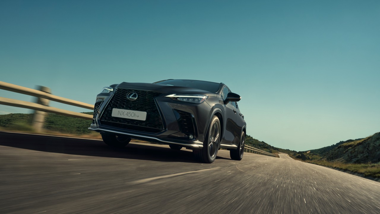 Lexus NX 450h+ driving on a road