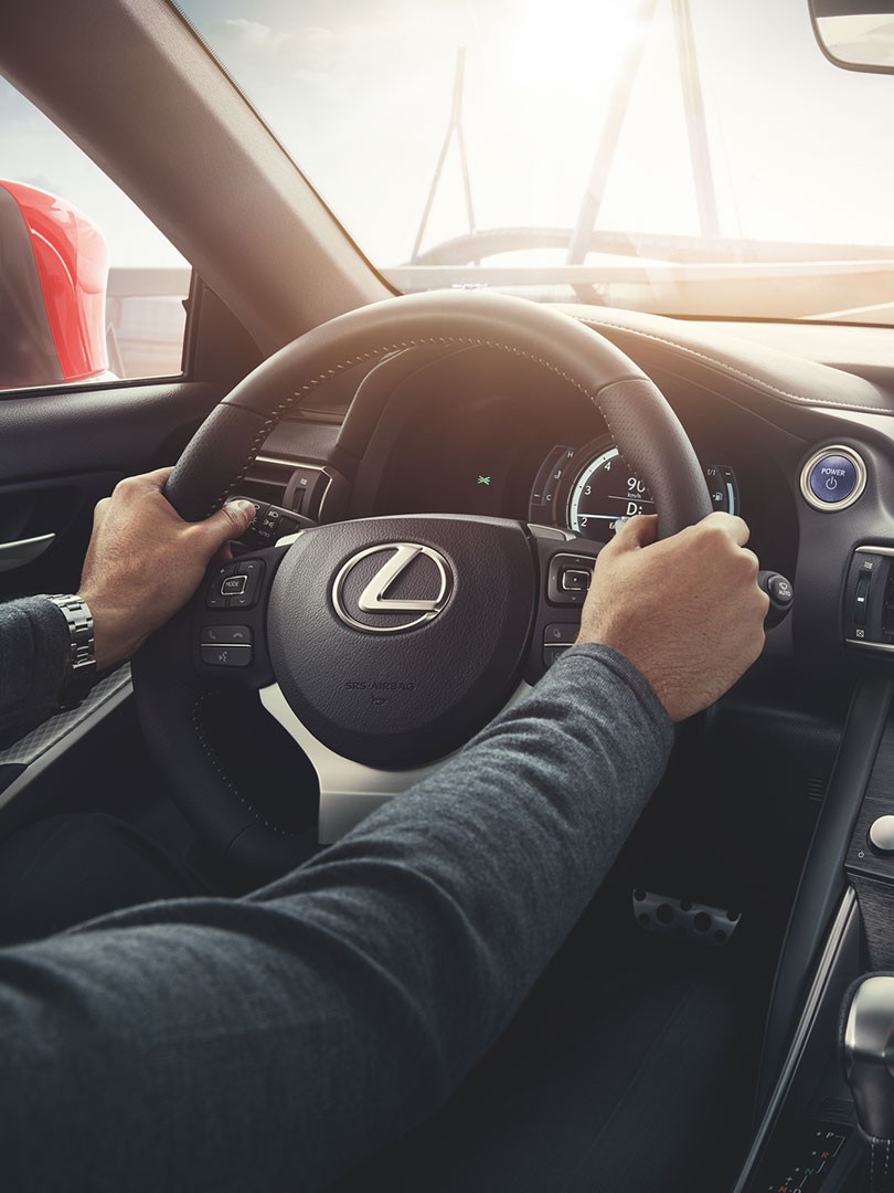two hands on a Lexus steering wheel