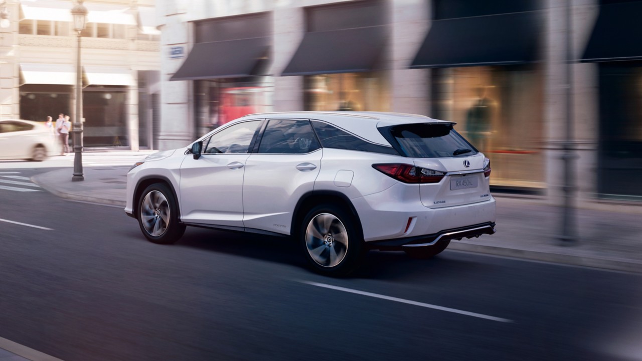 Lexus RX driving down a road