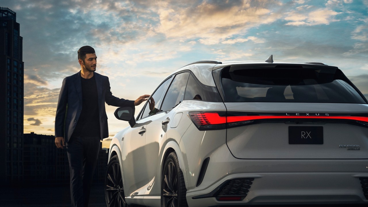 Person standing next to a Lexus RX