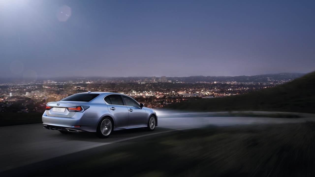 Lexus GS driving in the evening with a city background