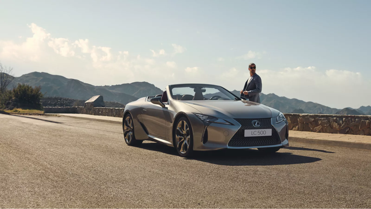 Lexus LC CV parked with a man standing next to it