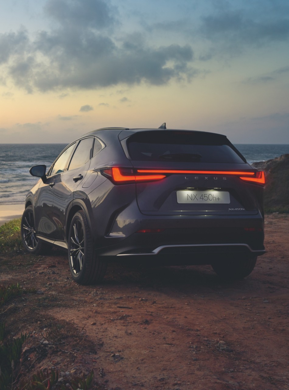 Lexus NX 450h+ parked next to the sea