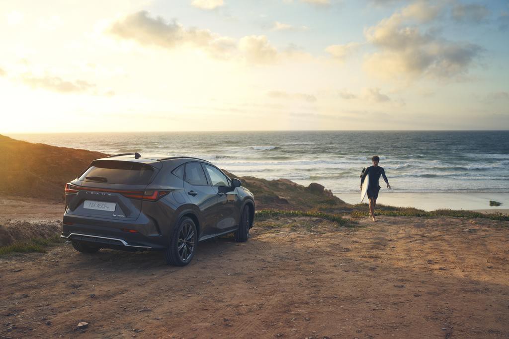 Lexus NX 450h+ plugged into a charging tower