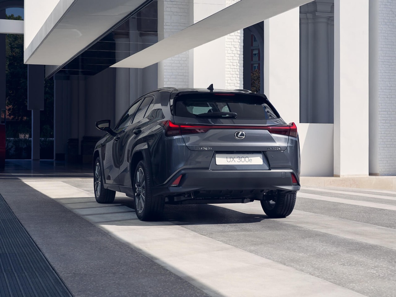 person pressing a button inside their Lexus UX 300e