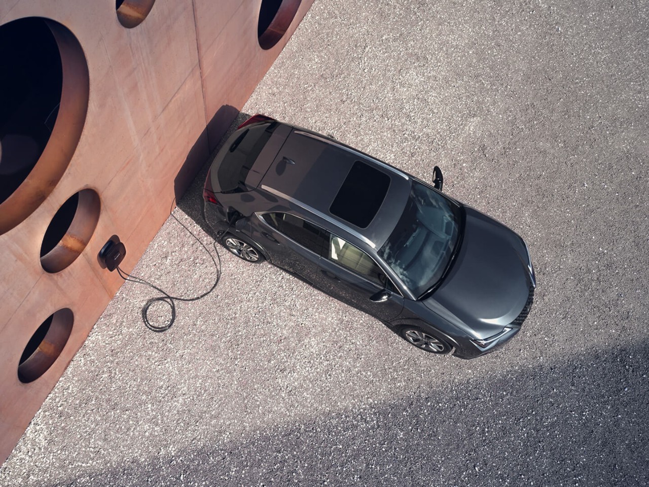 person pressing a button inside their Lexus UX 300e