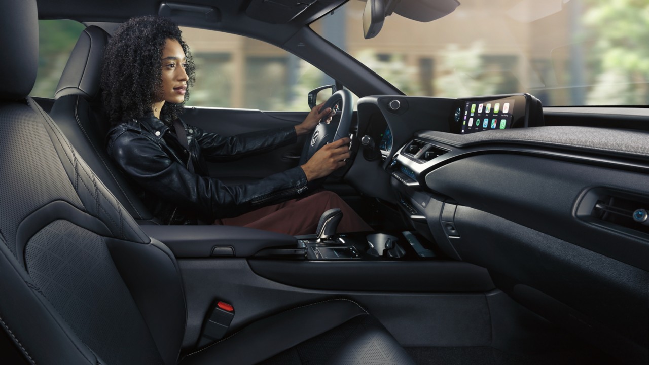 woman driving a Lexus UX 300e car