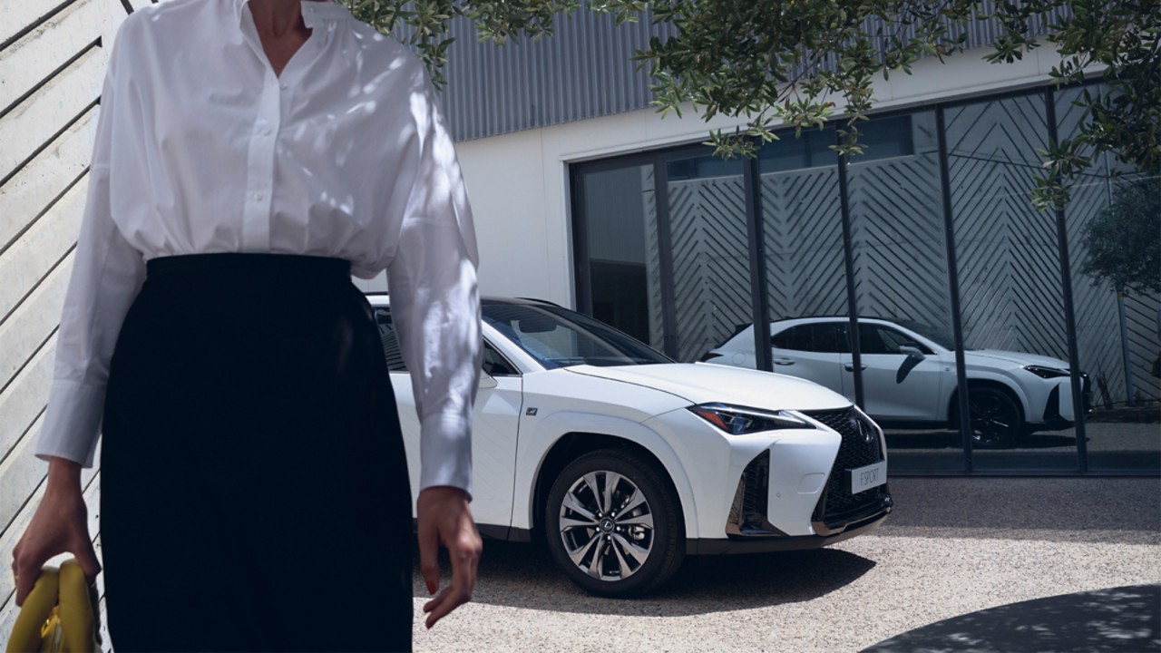 Lexus UX with woman in front