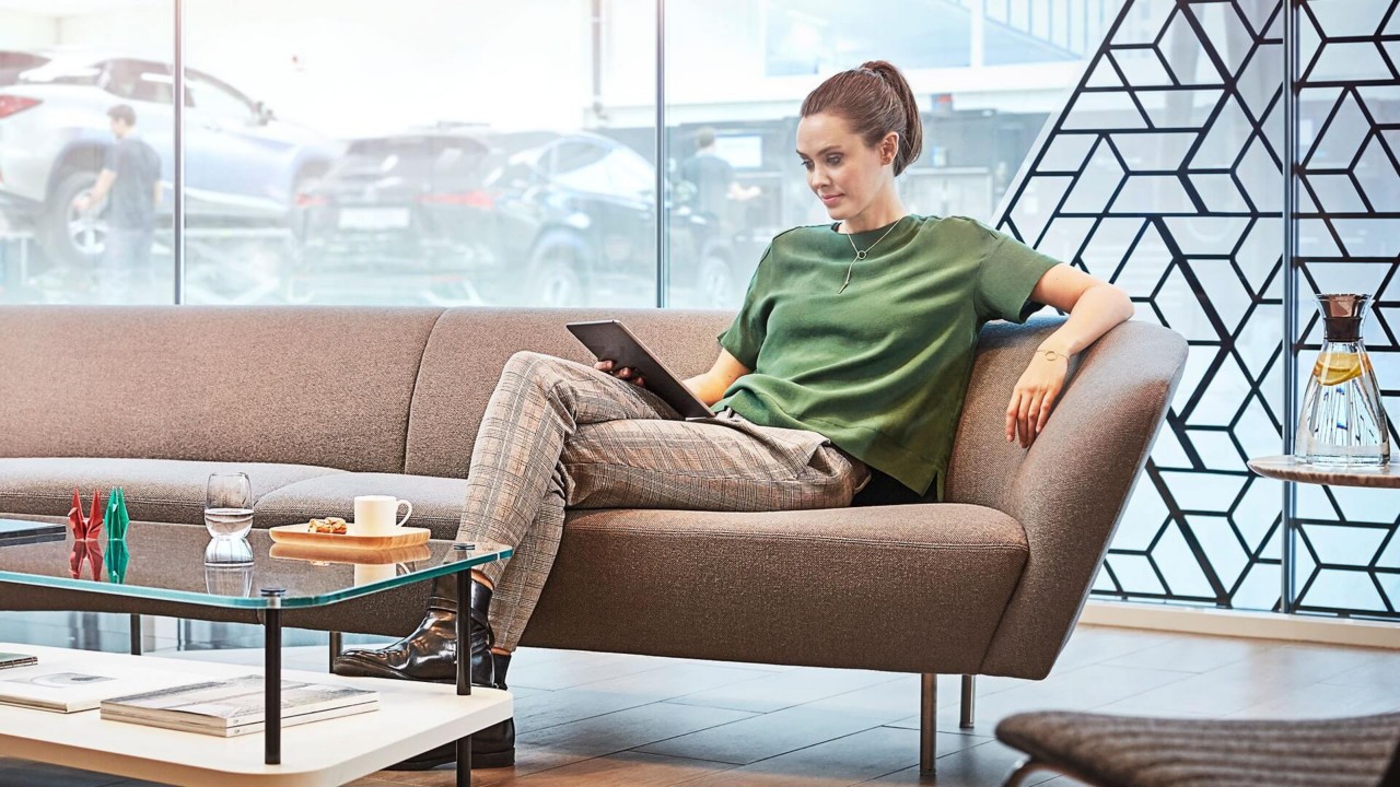 A woman sitting on a sofa reading