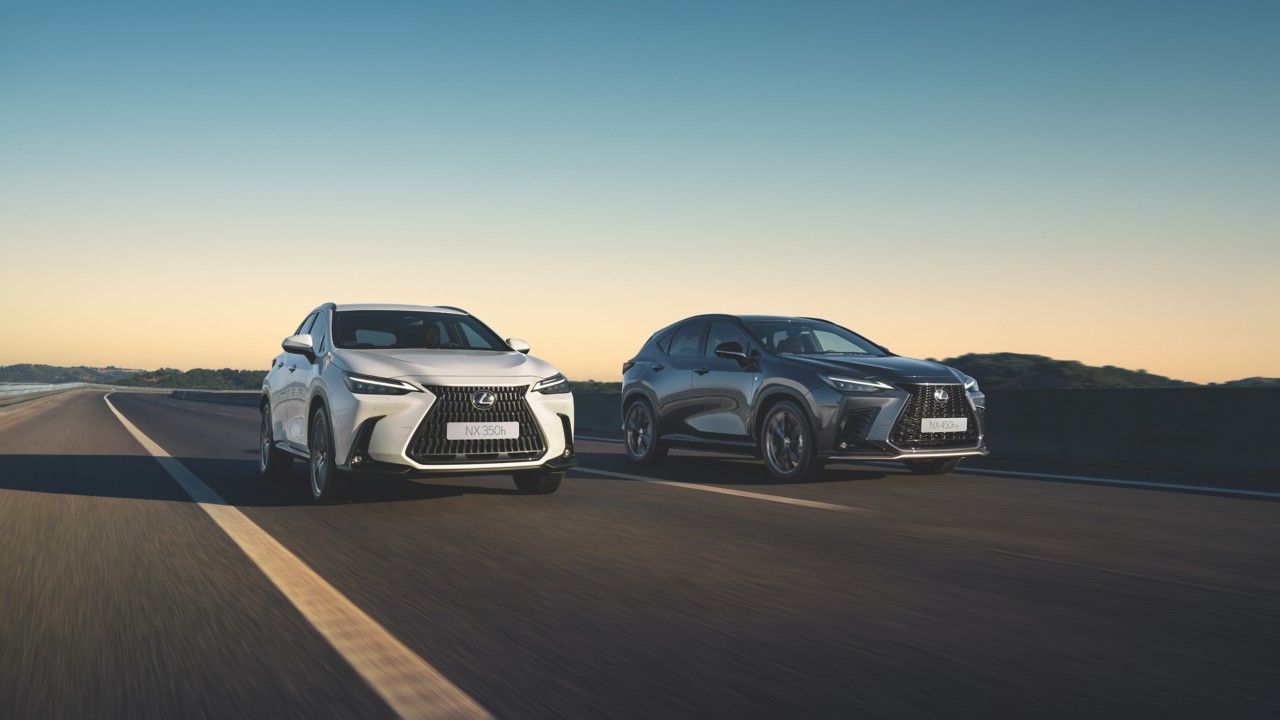 two Lexus NX cars driving on a road