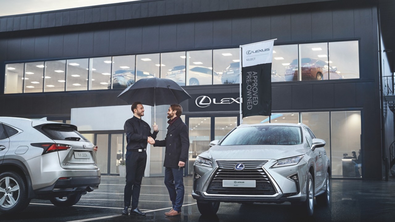 two people standing outside a Lexus centre