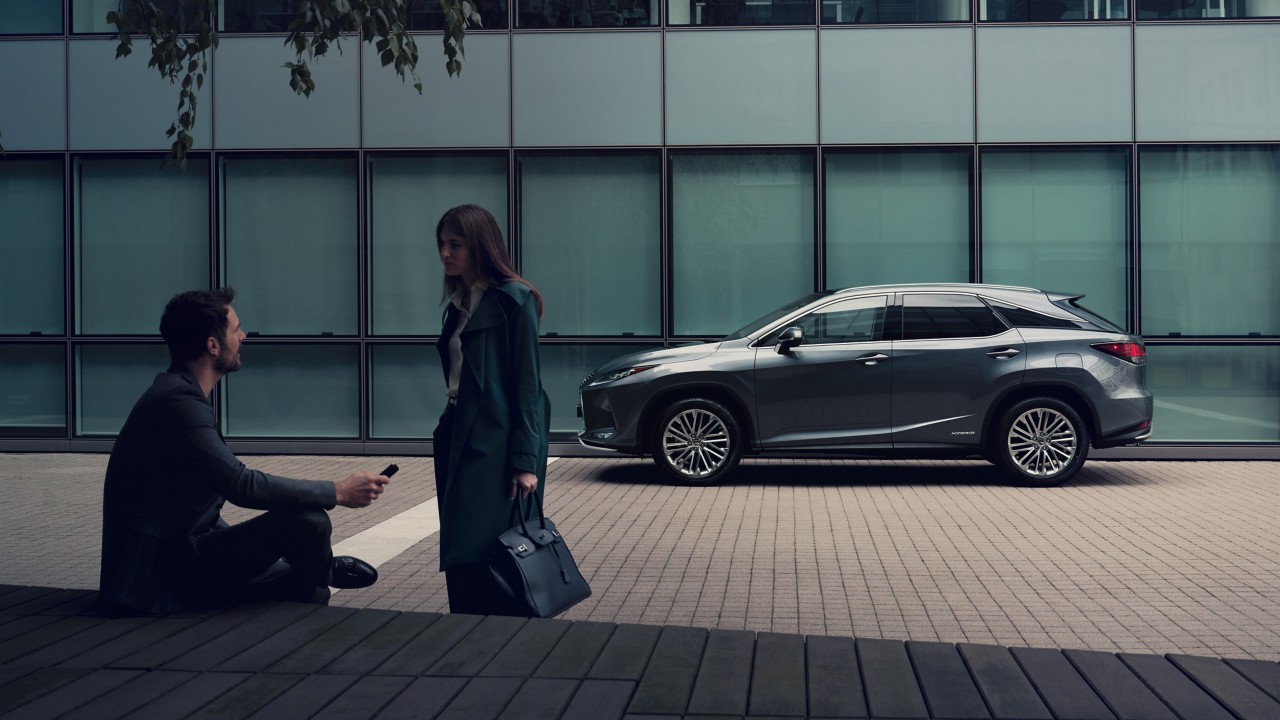 Two people infront of a Lexus