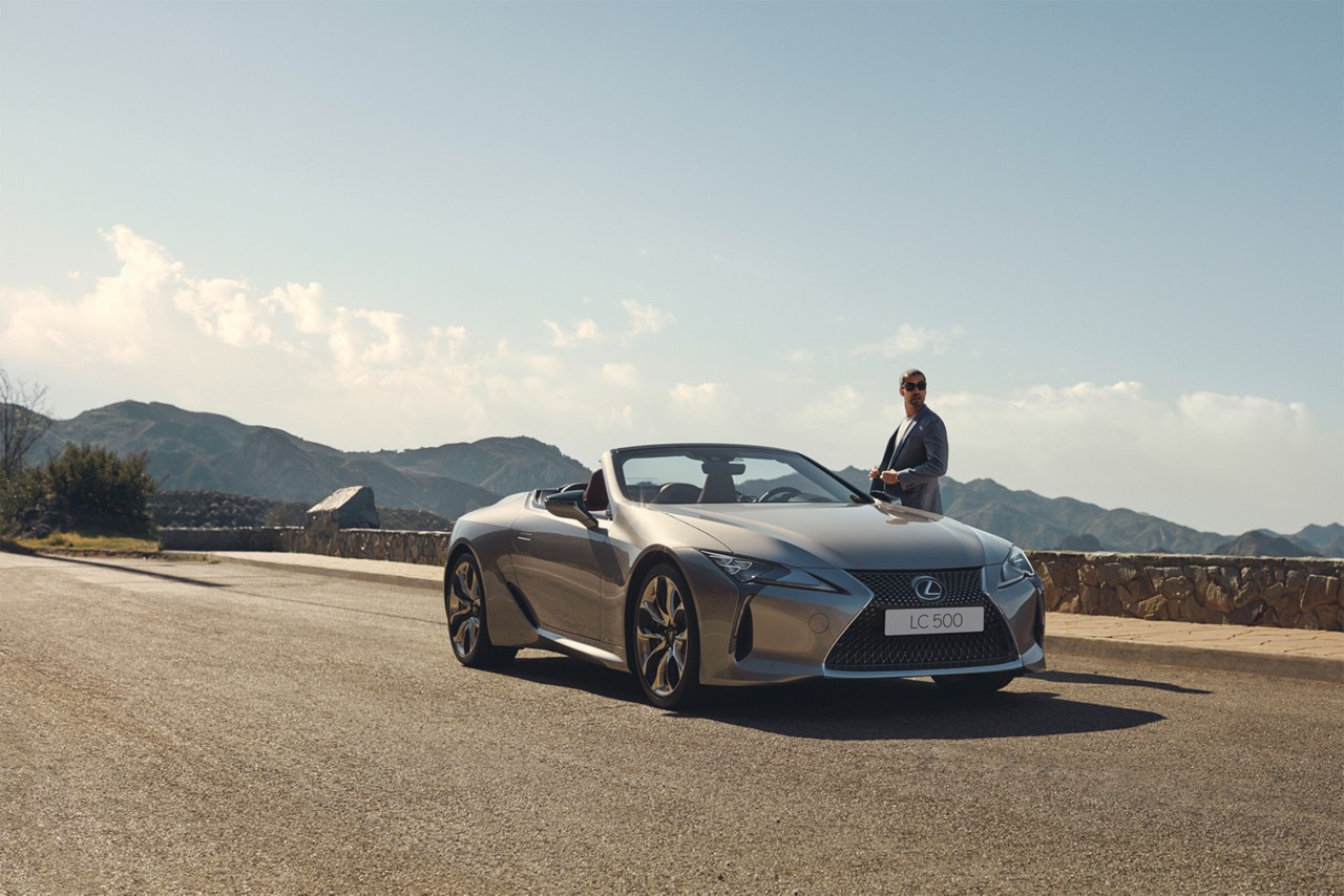 A man stood next to a Lexus LC Convertible