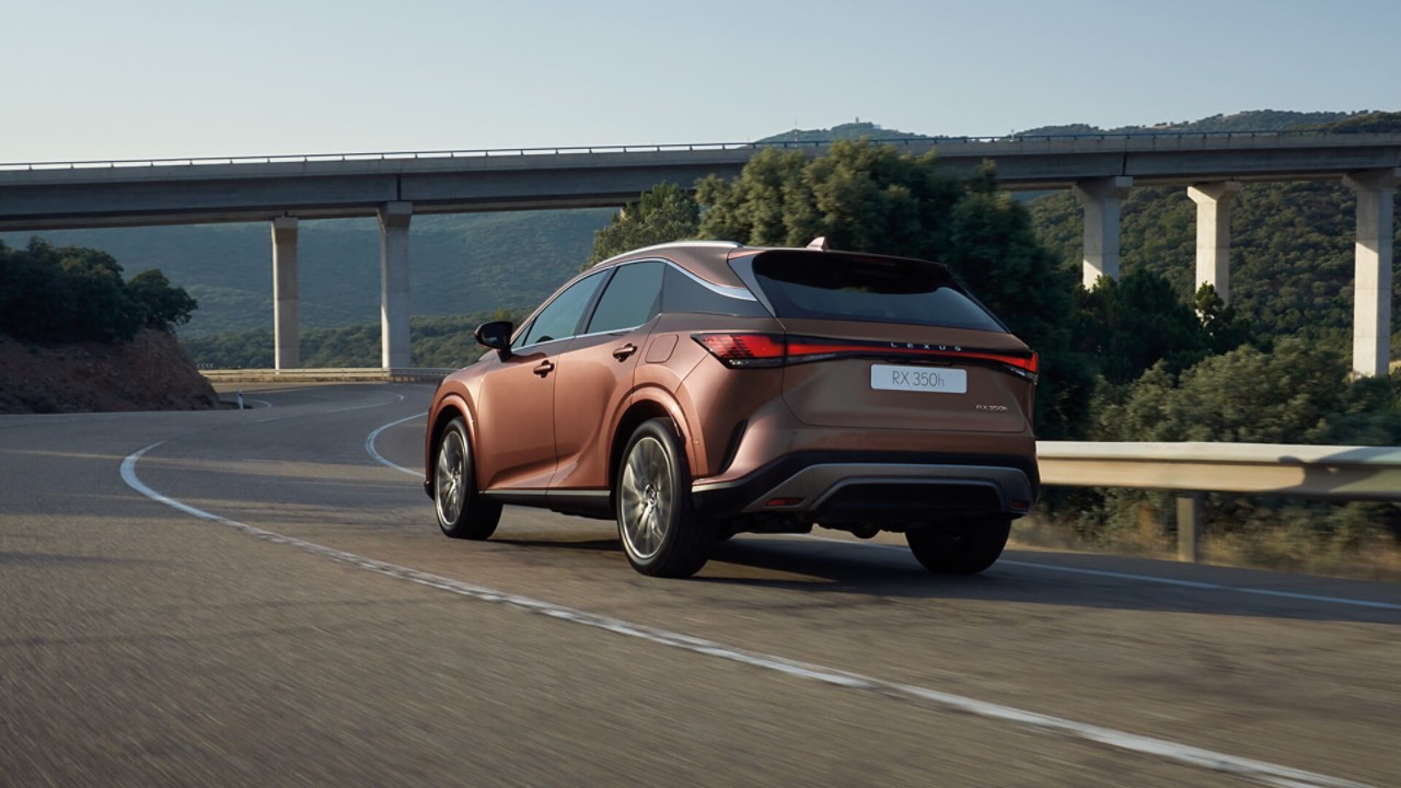 Rear view of a Lexus RX 300h driving in a mountainous location