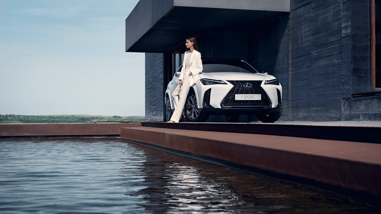 person leaning on a Lexus UX